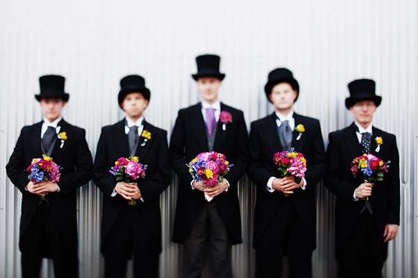 the groom and groomsmen pose with bright bouquets in this group portrait - photo by Dallas based destination wedding photographer Poser
